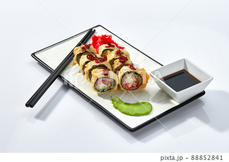 Hot Sushi roll isolated on white background. Traditional fresh Japanese Sushi roll with salmon, avocado, and philadelphia cheese 88852841