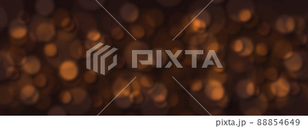 Abstract blurred orange confetti spots on a black background. 88854649