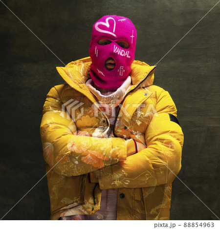 Contemporary art collage. Stylish man in pink balaclava and yellow jacket isolated over textured dark green background. Contemporary art collage. Stylish man in pink balaclava and yellow jacket isolated over textured dark green background. 88854963