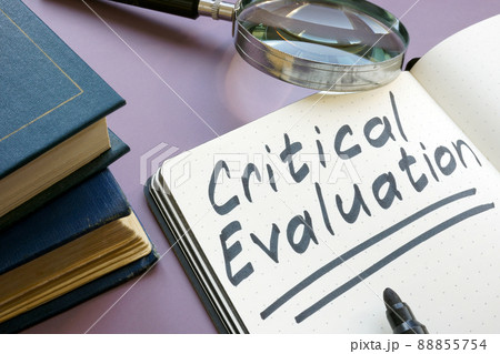Open notebook with critical evaluation sign and magnifying glass. Open notebook with critical evaluation sign and magnifying glass. 88855754
