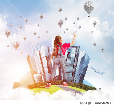 Concept of careless happy childhood with girl dreaming about future Concept of careless happy childhood with girl dreaming about future 88856204