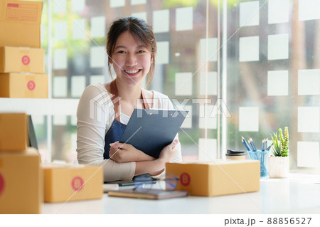 Asian small business owner working at home office. Business retail market and online sell marketing delivery, SME e-commerce concept. Asian small business owner working at home office. Business retail market and online sell marketing delivery, SME e-commerce concept. 88856527