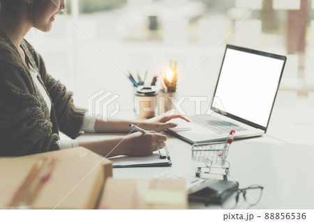 Asian small business owner working at home office. Business retail market and online sell marketing delivery, SME e-commerce concept. Asian small business owner working at home office. Business retail market and online sell marketing delivery, SME e-commerce concept. 88856536