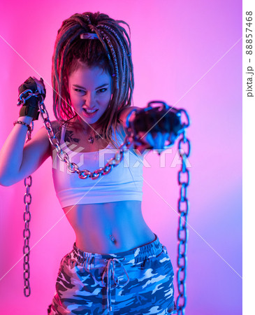 a fighter girl with chains on her hands with beautiful dreadlocks on her head in neon light 88857468