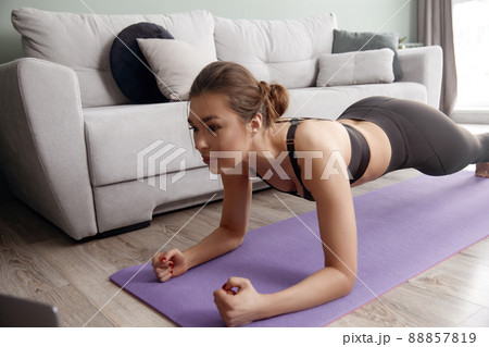 Girl training at home, woman doing plank 88857819