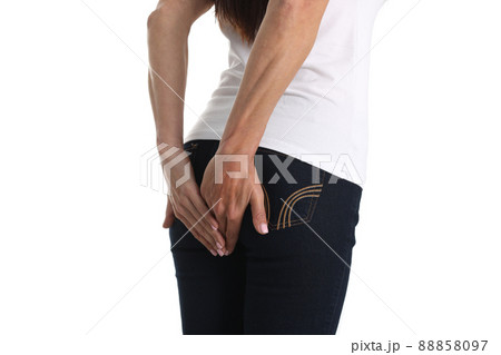 Woman holds hands on anus with stomach problems Woman holds hands on anus with stomach problems 88858097