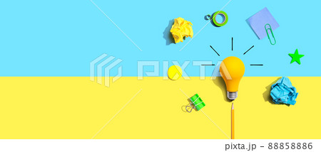 Brainstorming concept with a light bulb and school supplies - Flat lay 88858886