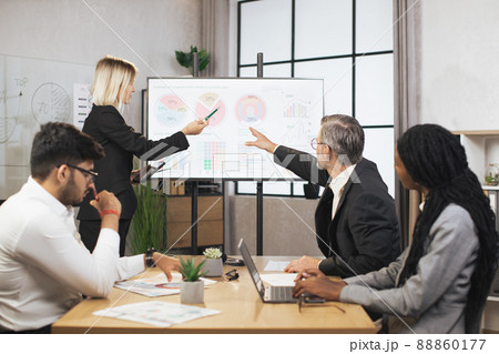 Group of businesspeople, sitting at the table and listening the marketing and financial report 88860177