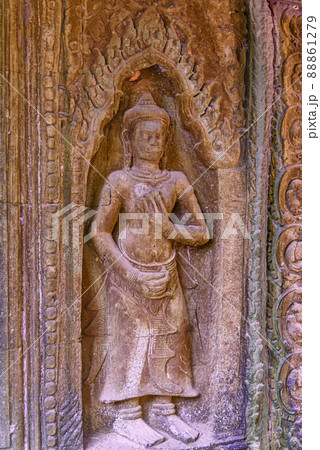 Detail of bas relief sculpture the wall of the ancient Ta Prohm temple in the Angkor Thom Area, Siem Reap, Cambodia. 88861279