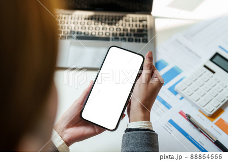 Cropped shot view of woman hands holding smart phone with blank copy space screen for your text message or information content. Cropped shot view of woman hands holding smart phone with blank copy space screen for your text message or information content. 88864666
