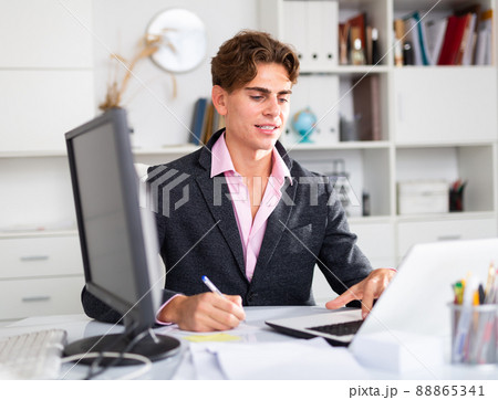 happy businessman working in his white office 88865341