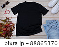 Mens black T-shirt mockup with wild grass and bracelet 88865370