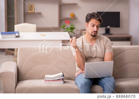 Young male employee working from house Young male employee working from house 88866070