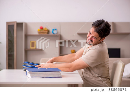 Young male employee working from house Young male employee working from house 88866071
