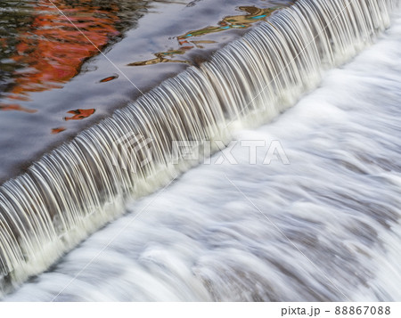 A small flat cascade in a calm river A small flat cascade in a calm river 88867088