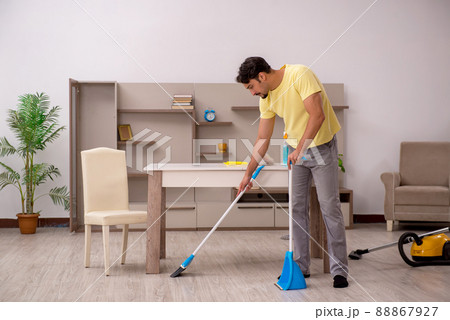 Young man doing housework at home Young man doing housework at home 88867927