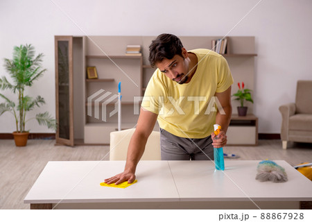 Young man doing housework at home Young man doing housework at home 88867928