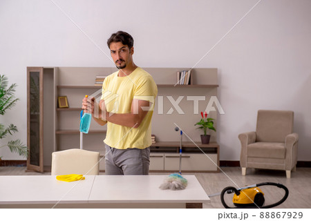 Young man doing housework at home Young man doing housework at home 88867929