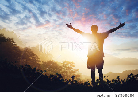 Copy space of man raise hand up on sunset sky 88868084