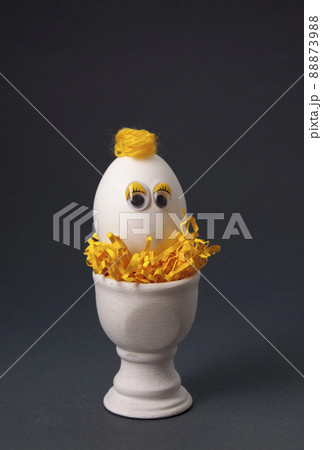 Egg in a stand on a dark background 88873988