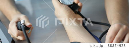 Doctor measuring patient blood pressure on arm using tonometer closeup 88874923