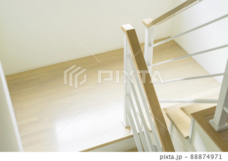 Modern design white wooden stairs. Stairs and a wooden banister and railing, close-up. Modern design white wooden stairs. Stairs and a wooden banister and railing, close-up. 88874971
