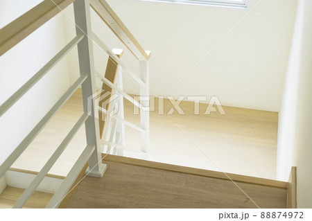 Modern design white wooden stairs. Stairs and a wooden banister and railing, close-up. Modern design white wooden stairs. Stairs and a wooden banister and railing, close-up. 88874972