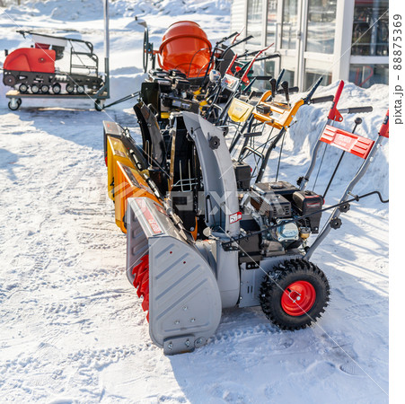 Kemerovo, Russia, February 17, 2022. A new petrol snowplow is on sale. Snow removal mechanism. A device for snow removal at home in winter. Kemerovo, Russia, February 17, 2022. A new petrol snowplow is on sale. Snow removal mechanism. A device for snow removal at home in winter. 88875369