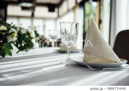 Wedding table setting for guests in a restaurant Wedding table setting for guests in a restaurant 88875446