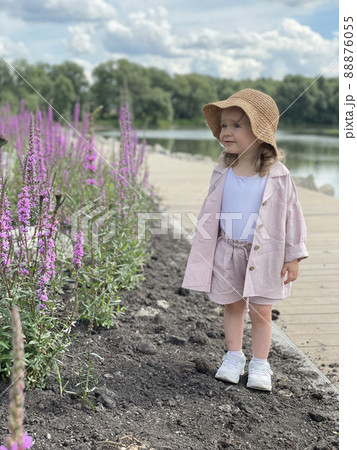 Baby girl in pin clothes and a straw hat 88876055