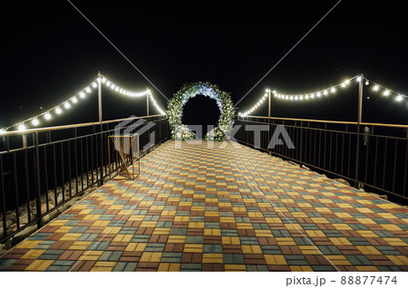 Round wedding arch decorated with fresh flowers. Evening ceremony 88877474