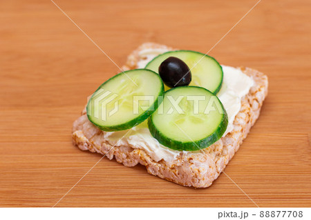 Rice Cake Sandwich with Fresh Cucumber, Cream Cheese and Olives 88877708