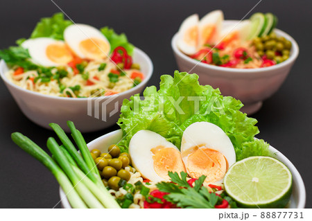 Noodle Dish with Green Onions, Eggs, Green Pea, Red Hot Pepper, Greens and Lime Noodle Dish with Green Onions, Eggs, Green Pea, Red Hot Pepper, Greens and Lime 88877731