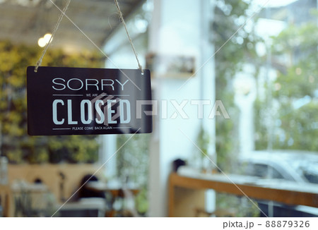 Business coffee cafe shop sign board is hang on door and show "Sorry We are Closed" with cafe and resturant blur bokeh background. Business coffee cafe shop sign board is hang on door and show "Sorry We are Closed" with cafe and resturant blur bokeh background. 88879326
