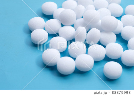 Naphthalene mothballs on blue backgrond. 88879998
