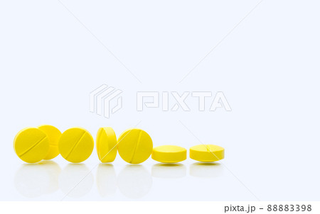 Yellow tablets pills on white background. Prescription drugs. Pharmaceutical industry. Healthcare and medicine. Pharmacy drugstore web banner. Tablets pills manufacturing industry. Healthcare industry 88883398