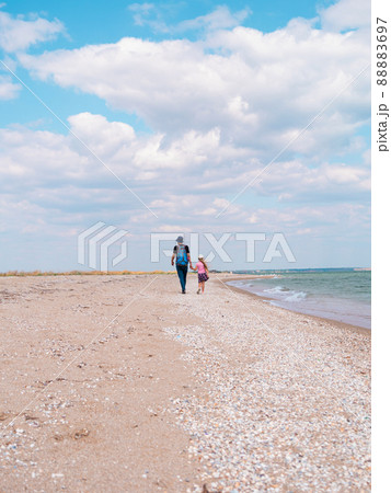 Happy father and daughter walking on beach marine landscape. Dad and child having fun running together. Fathers day Happy father and daughter walking on beach marine landscape. Dad and child having fun running together. Fathers day 88883697