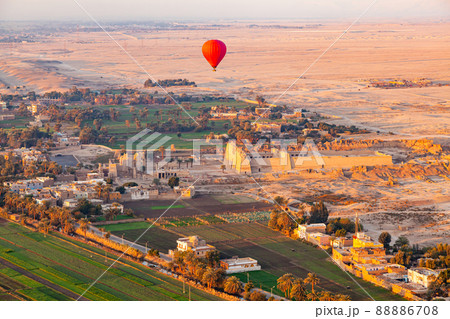 Hot air balloon flying above The Mortuary Temple of Ramesses III at Medinet Habu. Hot air balloon flying above The Mortuary Temple of Ramesses III at Medinet Habu. 88886708