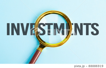 Successful business investments. Investment search concept. Magnifying glass over text - investments 88886919