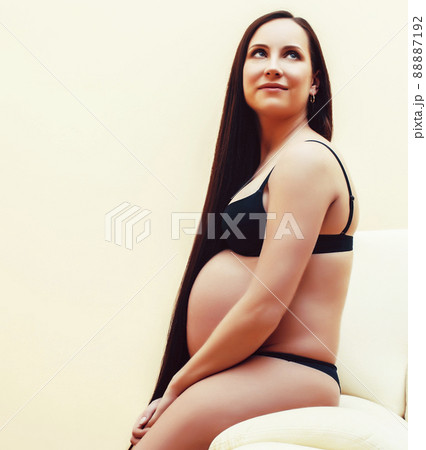 young brunette woman at home in chair pregnant, lifestyle people concept young brunette woman at home in chair pregnant, lifestyle people concept 88887192