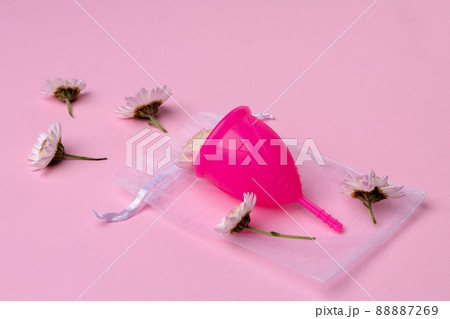Menstrual cup with flowers on pink background Menstrual cup with flowers on pink background 88887269
