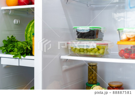 Storage containers with fresh food in a fridge 88887581