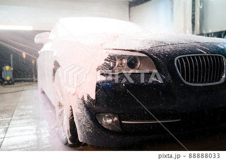 Applying foam to the car. Professional auto wash Applying foam to the car. Professional auto wash 88888033