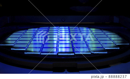 Silicon wafer with chips in UV lighting. Neon. Ultraviolet Lithography. 88888237