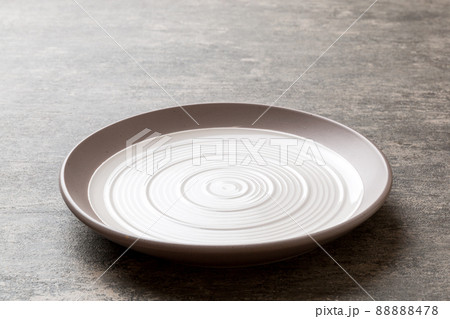 Perspective view of empty light plate on cement background. Empty space for your design 88888478