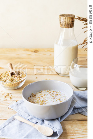 Healthy milky porridge from whole hulled grain oats in bowl with oat milk Healthy milky porridge from whole hulled grain oats in bowl with oat milk 88889029