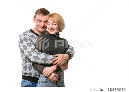 Portrait of a young couple, a man hugging a woman, isolated on a white background 88889259