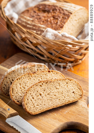 Sliced loaf of bread on cutting board. Sliced loaf of bread on cutting board. 88889929
