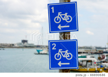blue square shaped bicycle lane route signs with route numbers on metal pole 88890686