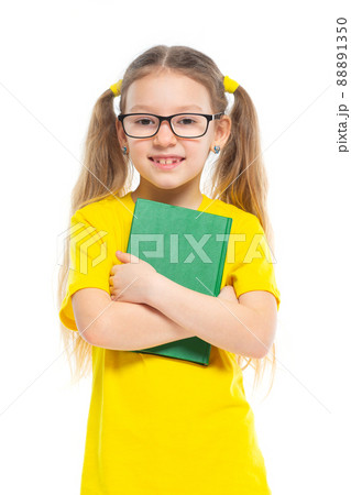 Cheerful young child girl with glasses holding a book to study isolated on a white background. 88891350